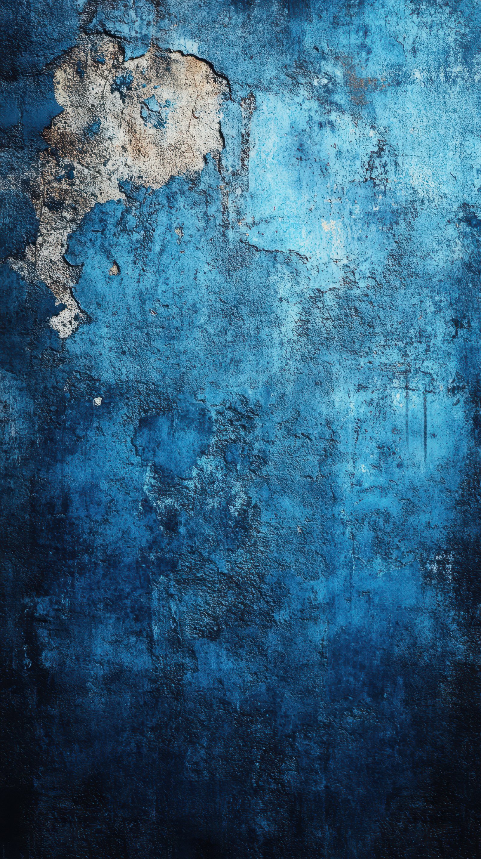 Textured blue wall with peeling paint reveals layers of history in a forgotten space